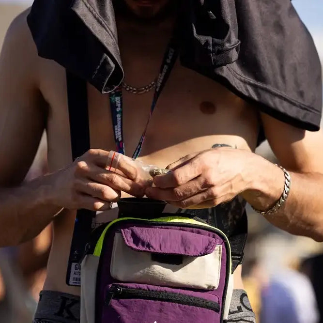 Man holding a bag of cannabis from his smell proof stash bag.