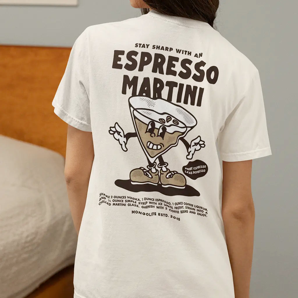 A woman wears a white vintage-style Espresso Martini T-shirt featuring a retro cartoon cocktail design and classic typography. Perfect for lovers of vintage T-shirts, nostalgic fashion, and fun graphic tees.