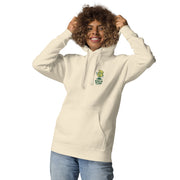 Female model wearing a beige Always on the Grind hoodie, showing the front chest grinder print.