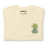 Folded front view of Always on the Grind T-shirt in beige with a weed grinder cartoon design.
