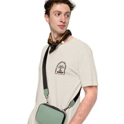 Front view of the Espresso Martini T-shirt in beige, worn by a male model, featuring a small left chest print of a cartoon martini glass.