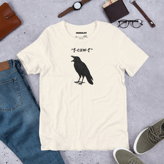 Vintage White “F-caw-f” t-shirt laid flat on concrete with accessories including watch, glasses, and denim jeans.