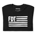 Flat lay of black FDT protest tee with bold white brushstroke print