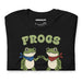 Folded black t-shirt showing the full “Frogs Together Strong” graphic with fist-bumping frogs and chunky lettering.