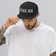 man wearing black Fuck ICE snapback, looking down