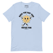 Baby blue t-shirt with a vintage-style sun illustration and the text "Have The Day You Voted For" in bold, retro-inspired font.
