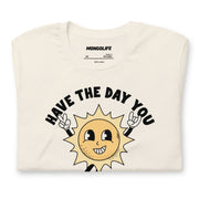 Neatly folded vintage white t-shirt showcasing the "Have The Day You Voted For" design with a playful sun illustration.