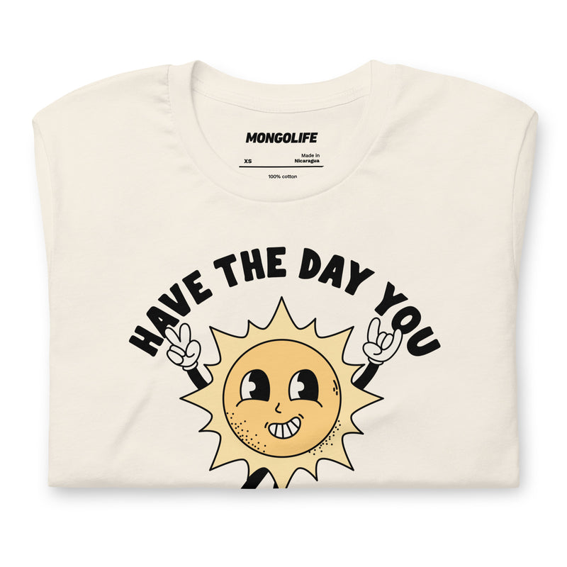 Neatly folded vintage white t-shirt showcasing the "Have The Day You Voted For" design with a playful sun illustration.