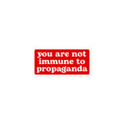 "You Are Not Immune to Propaganda" sticker designed to spark conversation and critical thinking.