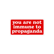 "You Are Not Immune to Propaganda" sticker in striking white text on a red background.