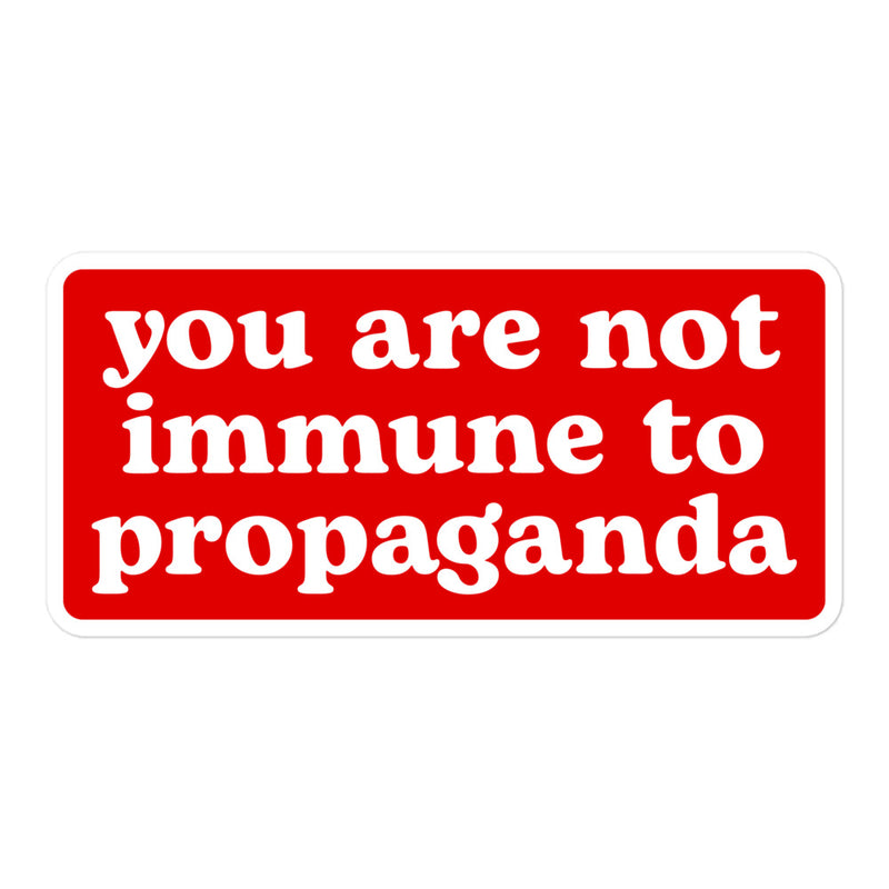 A high-contrast red sticker with the phrase "You Are Not Immune to Propaganda."