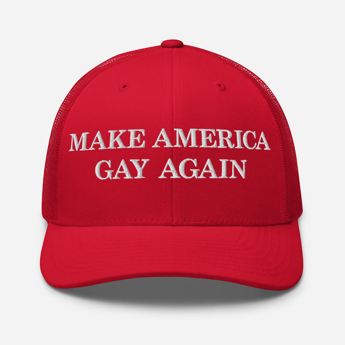 Red trucker hat with white “Make America Gay Again” embroidery, front view showing structured crown.