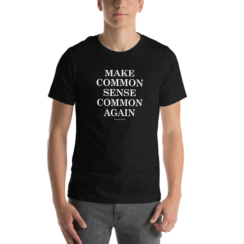 Model wearing black “Make Common Sense Common Again” t-shirt with white text, showcasing fit and print placement.
