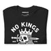 Vintage black t-shirt neatly folded to show the central skull-and-crown artwork and bold protest message.