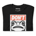 Folded black tee featuring the “Portland Frogs Don’t Obey” design visible on front chest area.