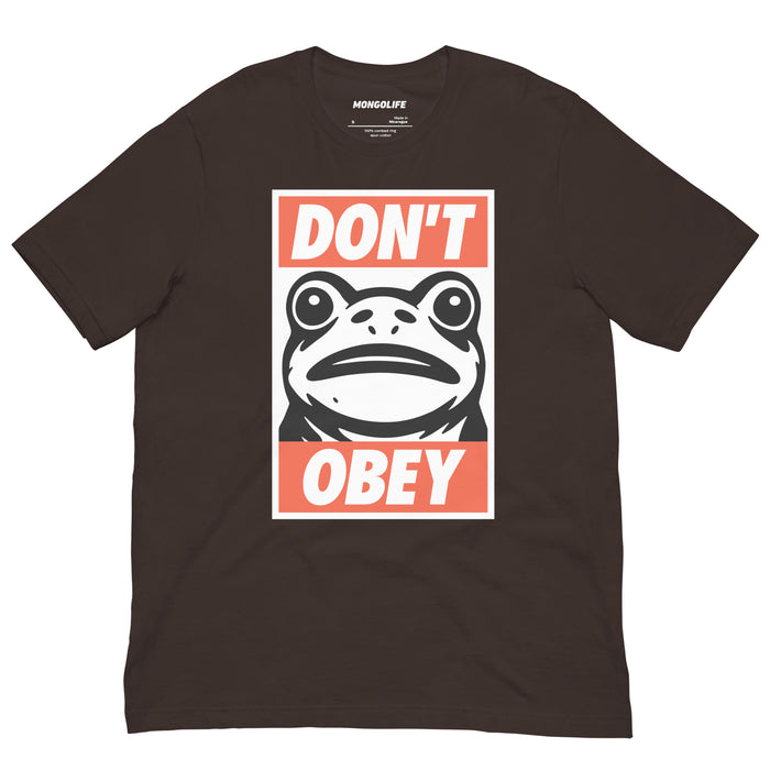 Brown t‑shirt featuring the same “Portland Frogs Don’t Obey” print with frog iconography and statement slogan.