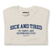 Folded Heather Dust Sick and Tired T-shirt, showcasing the bold text design and soft fabric texture.