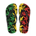 Rasta-colored cannabis leaf pattern on flip-flops against a black background.