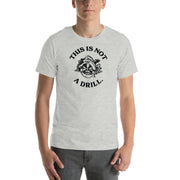 A model wearing the athletic heather "This Is Not A Drill" t-shirt, showcasing the humorous circular saw design in a casual setting.