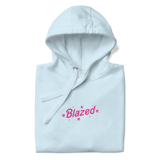 Folded sky blue hoodie with 'Blazed' logo in pink, adorned with stars and cannabis leaves.