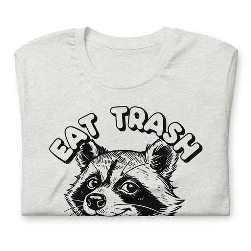 Folded t-shirt with a “Eat Trash Do Crime” raccoon illustration in Ash color