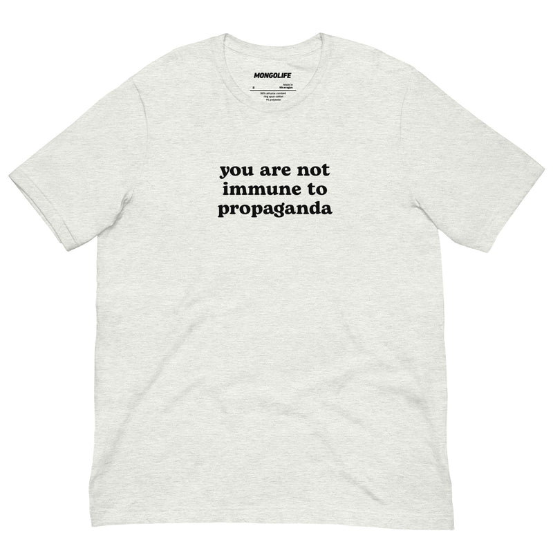 Light ash grey t-shirt with the phrase "You Are Not Immune to Propaganda" in bold black text.