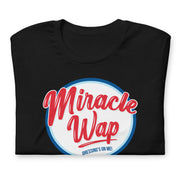 Black folded Miracle Wap t-shirt with parody logo and "Dressing's on me!" text.