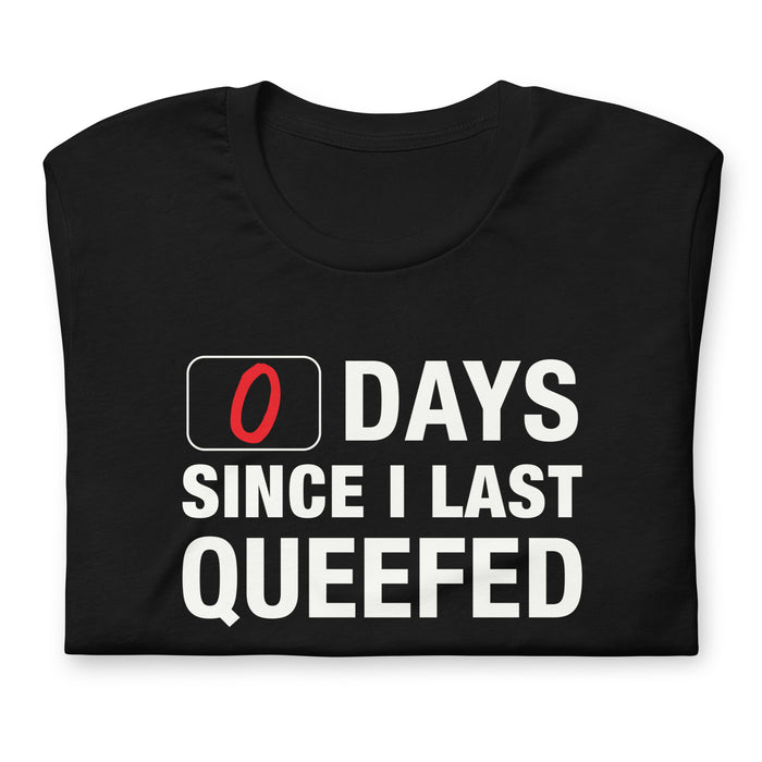 Folded black 0 Days Since I Last Queefed t-shirt with bold text.