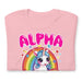 pink folded Men's t-shirt with 'Alpha Male' text, unicorn, and rainbow design.
