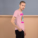 man wearing a pink Men's t-shirt with 'Alpha Male' text, unicorn, and rainbow design.