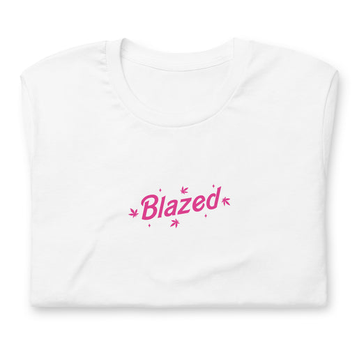 Folded white casual tee with 'Blazed' logo in pink, decorated with stars and cannabis leaves.