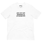 Classic white t-shirt with the "You Are Not Immune to Propaganda" message in bold black typography.