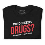 Folded black Who Needs Drugs? T-shirt showcasing crisp red and white lettering on soft cotton fabric.