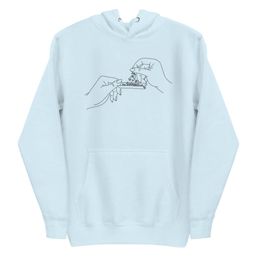 Black and white line art of two hands rolling a joint with flowers, meticulously embroidered on the front chest of a soft, sustainable baby blue hoodie.