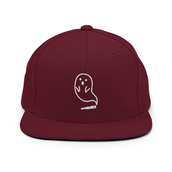 Embroidered ghost design emerging from a cannabis joint on a red snapback hat, perfect for Halloween.