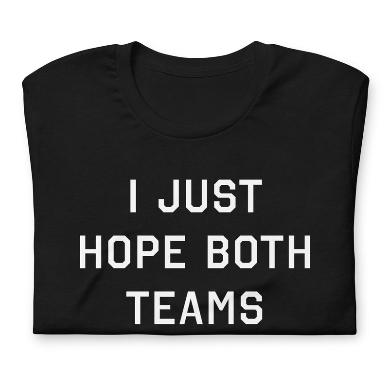 Folded up funny black sports t-shirt with the text "I Just Hope Both Teams Have Fun"