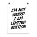 Poster print with bold black brush-style text reading “I’m not weird, I am limited edition” on a white background with metal clips.