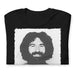 Folded Black t-shirt on a white background, with the mugshot of Jerry Garcia from Grateful Dead. Distressed and grunge edges. Black and white photo.