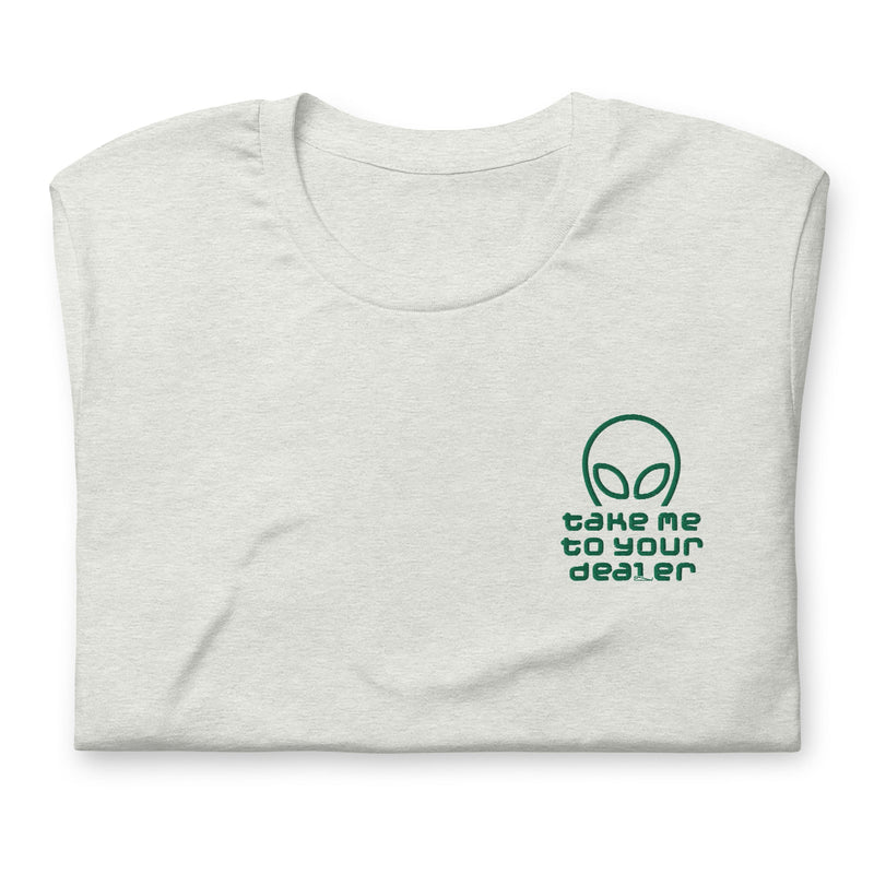 Folded Ash gray T-shirt with ‘Take Me to Your Dealer’ embroidered alien graphic on the left chest pocket area.